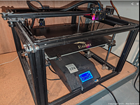 Front view of the Creality Ender 5 Plus 3D printer showing the black aluminum frame and heated bed.