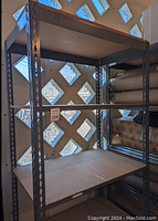 Full view of the shelving unit showing the metal frame with wood shelves inside a windowed room.