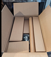 Overhead view of boxed kit with multiple smaller boxes and cardboard tube