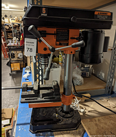 Front view of the drill press showing motor, table, and vise attached