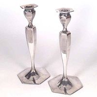 Front and side view of two silver plated antique candle holders by Jennings Brothers, showing hexagonal bases and polished finish.
