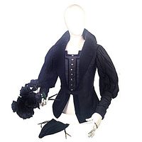 Front and partial side view of the black velvet Elizabethan jacket showing silver buttons, puffed sleeves and wide collar, displayed on mannequin with matching codpiece.