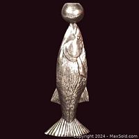 Front view of the cast metal figural fish candlestick showing detailed fish shape and candle cup at mouth.