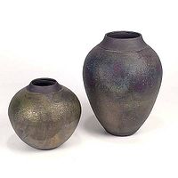 Two iridescent raku pottery vases, one squat and one tall, shown with matte textured surfaces and muted metallic colors.