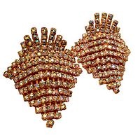 Close-up view of pair of vintage aurora borealis rhinestone shoe clips showing prong-set rhinestones arranged in a fan-like shape with gold-tone metal backing.
