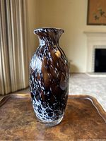 Full view of the vintage brown glass vase with white swirls showing shape and design.