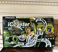 Front and side of box showing Mega Bloks Magnext iCoaster roller coaster set with image of roller coaster, child playing, and features including magnetic tracks and MP3 player compatibility.