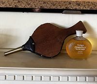 Wooden bellows and Houbigant Chantilly Eau de Cologne bottle side by side, showing whole bellows and Cologne bottle