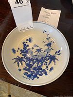 Top view of plate showing blue floral pattern and measurements note