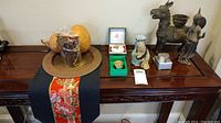 Full lot on wooden table: runner, charger with gourds and potpourri, trinket boxes, figurines, cup