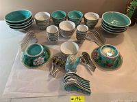 Overview of all bowls arranged with spoons and teapot