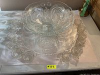 Full view of the entire set including the punch bowl, serving tray, and 12 cups arranged around the tray on a table surface.