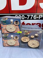 Four boxed International stoneware sets, two 20-piece and two 5-piece, in 774 Heartland pattern with farm-themed design on boxes