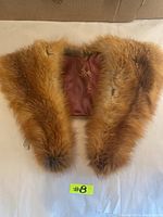 Full view of the red fox fur collar showing reddish-brown fur and satin lining inside.