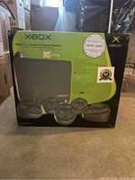 Front of retail box showing product image of five satellite speakers and subwoofer