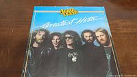 Front cover of April Wine Greatest Hits vinyl record showing the band members and album title.