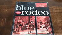 Front cover of Blue Rodeo Diamond Mine vinyl record showing band members playing instruments and price sticker.