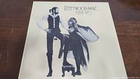 Front cover of Fleetwood Mac Rumours vinyl album featuring band members in stylized black and white photo.