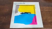 Front cover of Genesis Abacab vinyl record album showing colorful abstract artwork and title.