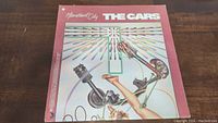 Front vinyl album cover of "Heartbeat City" by The Cars showing stylized artwork and title.