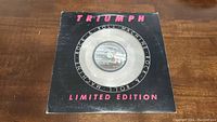 Front cover of the limited edition Triumph Rock & Roll Machine vinyl record in its sleeve, showing wear and a clear window at center for the vinyl label.