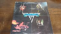 Front cover of Van Halen vinyl album showing band members performing with logo in center.