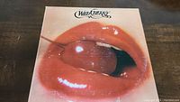 Front cover of Wild Cherry vinyl album featuring lips holding cherry.