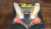 Front cover of ZZ Top Eliminator vinyl LP showing stylized red hot rod car graphic