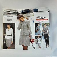 Folded uncut Vogue sewing patterns showing front cover images of professional women's outfits including skirts, jackets, pants, and dresses from the Career Wardrobe series.