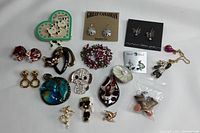 Full spread of assorted costume jewelry including pendants, earrings, and brooches in various colors and shapes