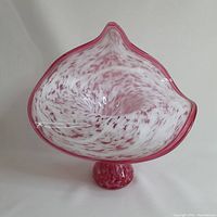 Front view of pink and white Jack-in-the-Pulpit style glass vase showing flared, curving top and rounded base with mottled color pattern.