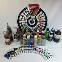 Full view of assorted acrylic paint supplies including tubes, bottles, and display rack.