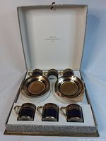 Full boxed set of six coffee cups and six saucers in original box with label on interior lid.