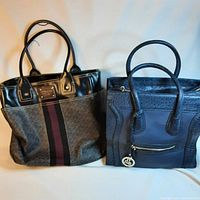 Two bags side by side on white background: brown Tommy Hilfiger tote with stripe and black structured it bag
