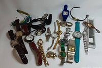 Full lot view showing assortment of 16 watches including leather, metal, and silicone straps in various colors and styles