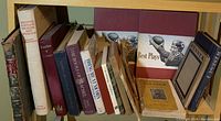 Shelf with 17 books including various vintage and signed editions, visible spines and covers of titles like Castles 1926 and The Book of Rachel