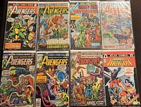 Eight mixed vintage comic books displayed flat including multiple Avengers issues from Marvel Comics Group and The Hands of Dragon from Atlas Comics.
