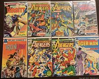 Photo showing 8 comic books laid out, including Marvel Avengers and various Atlas Comics issues like Targitt, Iron Jaw, Dragon Vampire, and Tiger-Man.