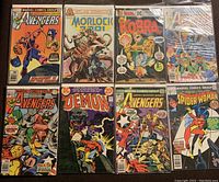 Photo showing all 8 comic books laid out in two rows, featuring various titles including Avengers, Morlock 601, Kobra, Demon and Spider-Woman
