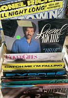 Photo of first few records stacked showing Lionel Richie, The Cover Girls, and others.