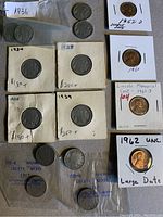 Photo showing Liberty Nickels and Buffalo Nickels in holders and plastic bags, including 1934, 1929 dates and early 1900s dates.