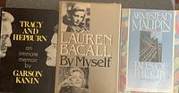 Photo of three books: Tracy and Hepburn An Intimate Memoir by Garson Kanin, Lauren Bacall By Myself, and Armistead Maupin Tales of the City Volume 1, showing front covers.