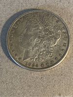 Obverse side of the 1884 Morgan silver dollar coin showing Lady Liberty and date 1884.