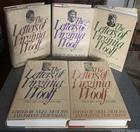 Five hardcover books in dust jackets with varying colors and portraits of Virginia Woolf; spines and front covers visible for all volumes.