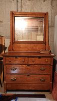 Full view of the antique oak dresser with attached mirror showing overall condition, drawer arrangement, and mirror frame.