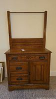 Front view of oak antique dry sink with towel bar and drawers