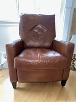 Front view showing brown leather upholstery, seat cushion and square armrests