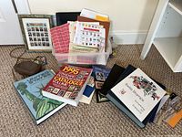 Wide view of all stamp collecting materials including albums, a stamp catalog, and foreign currency bag.