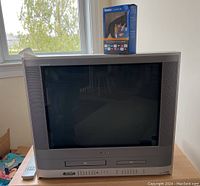 Front view of Toshiba TV/DVD/VCR combo with Roku Express+ box on top