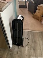 Front view showing black curved grille and base of the air cleaner